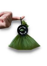 Load image into Gallery viewer, Dog poop bag clip held in hand for size