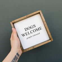 Load image into Gallery viewer, "Dogs Welcome (People Tolerated)" dog wood sign shown with its stained pine frame