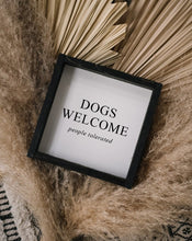 Load image into Gallery viewer, "Dogs Welcome (People Tolerated)" framed wood sign — angled view showing the frame depth