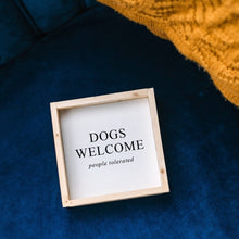 Load image into Gallery viewer, "Dogs Welcome (People Tolerated)" funny dog sign — detail of the frame corner and finish

