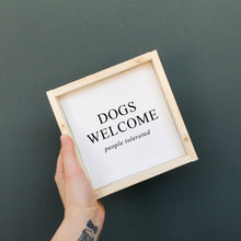 Load image into Gallery viewer, "Dogs Welcome (People Tolerated)" wood sign styled on a shelf as home decor
