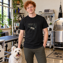 Load image into Gallery viewer, Illustrative lifestyle view of a man wearing the Exhibit A lint roller T-shirt with a terrier
