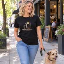 Load image into Gallery viewer, Separation Anxiety Is Mutual dog lover T-shirt in Black, front view on a blonde woman walking a dog near a café; illustrative lifestyle mockup
